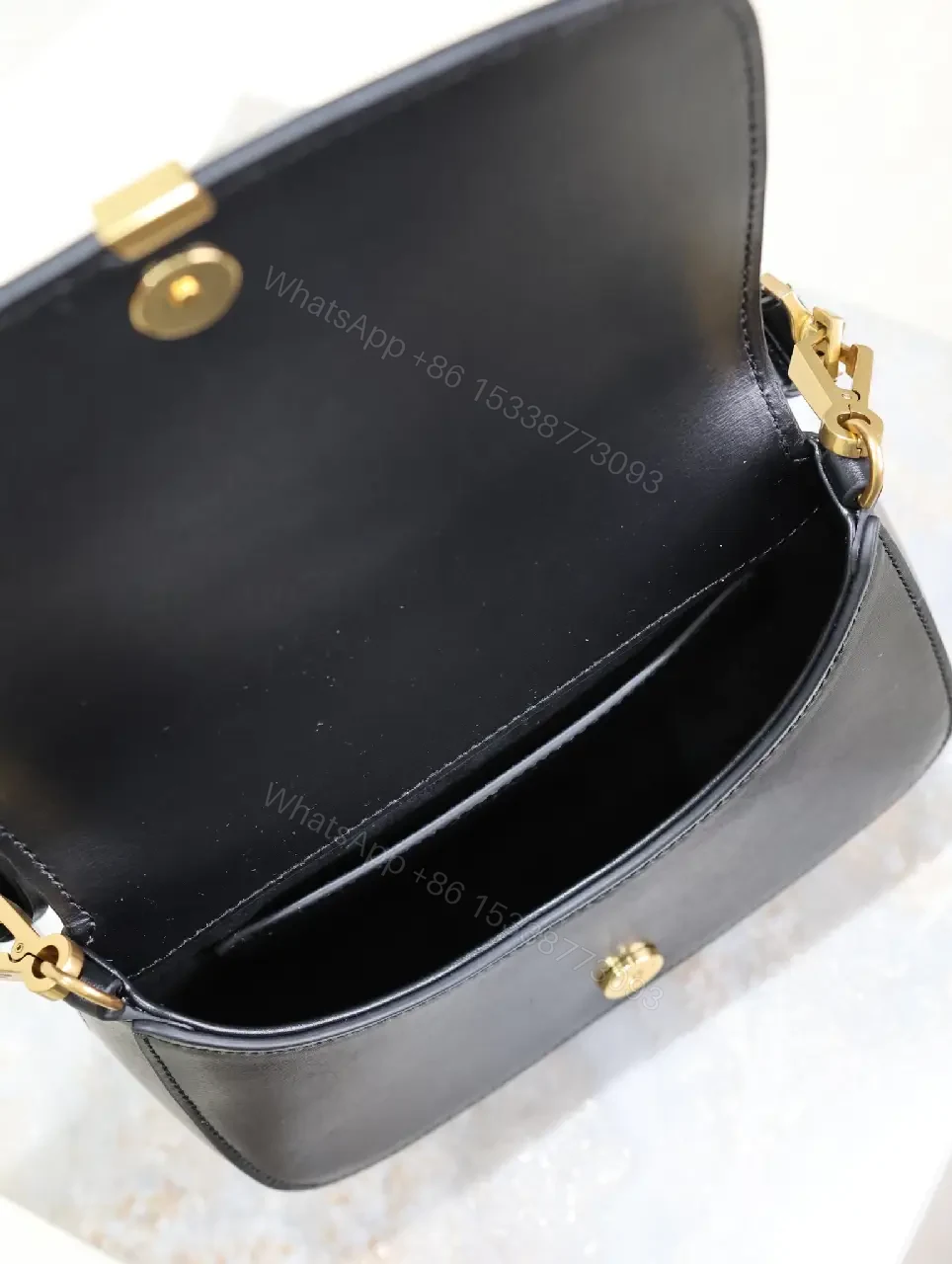 View 6 of Structured Leather Crossbody with Gold Emblem, Compact & Versatile Bag