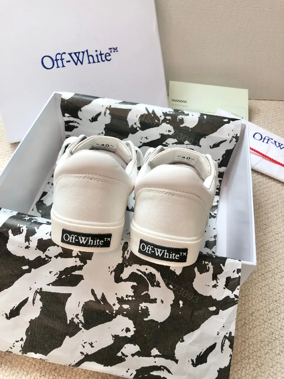 View 4 of Minimalist White Leather Low-Top Sneakers with Signature Detail