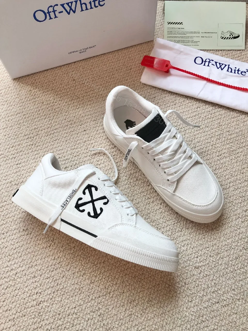 View 8 of Minimalist White Leather Low-Top Sneakers with Signature Detail
