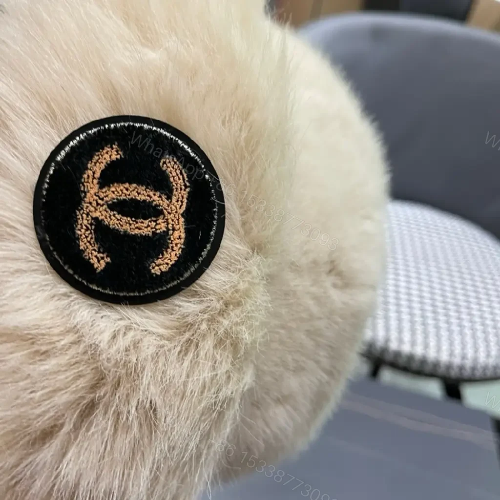 View 4 of Cream Faux Fur Pom Hat: Lux Soft Warmth, Subtle Logo Accent