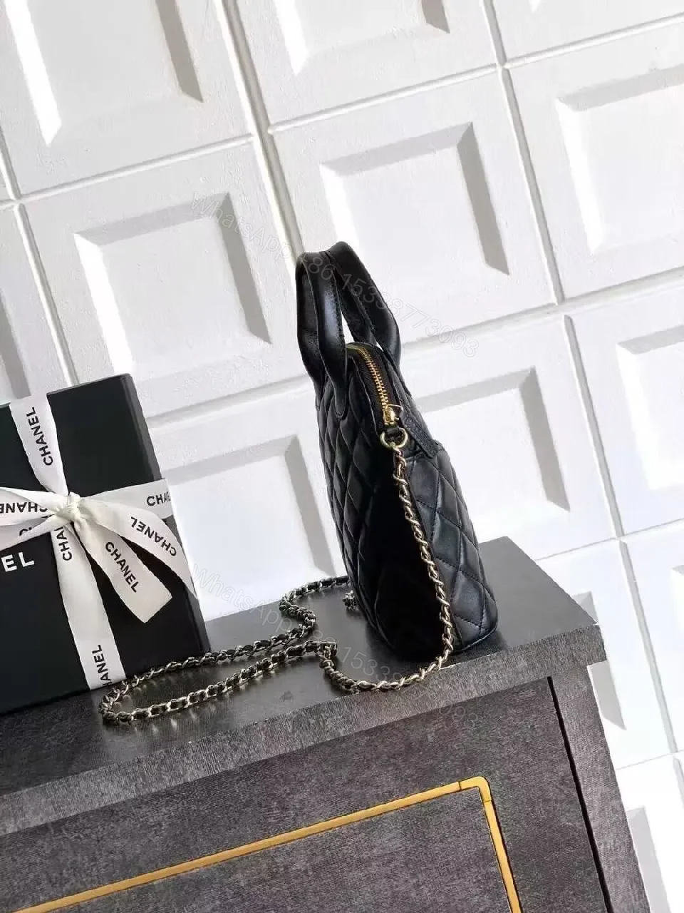 View 2 of Mini Quilted Black Bag with Gold Logo—Refined Daily Companion