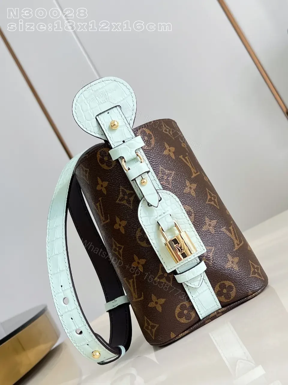 View 5 of Brown Monogram Bucket Bag: Structured Crossbody with Aqua Strap